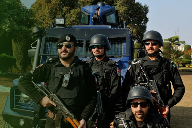 A police constable in uniform, standing on duty.