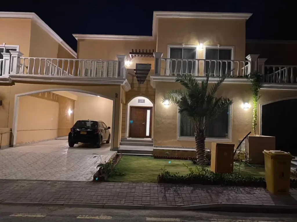 Bahria town house with car parked and porche lights on