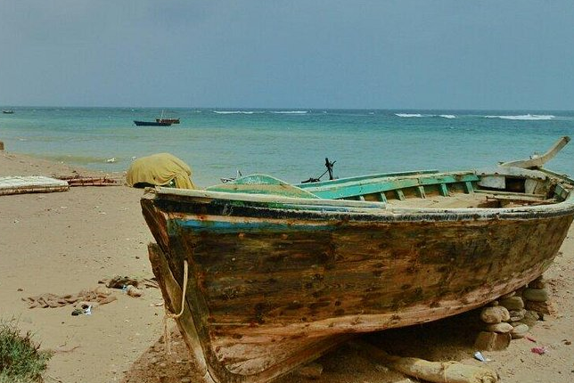 Fishermen preparing nets on the shore at Mubarak Village.