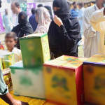 A low-income family receiving discounted groceries under the Punjab Ehsaas Rashan Riayat Program.