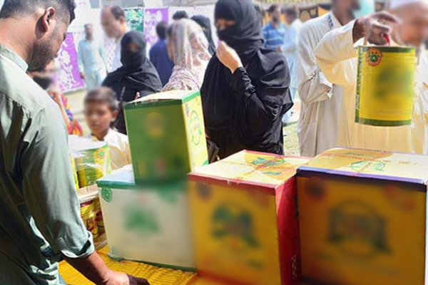 A low-income family receiving discounted groceries under the Punjab Ehsaas Rashan Riayat Program.