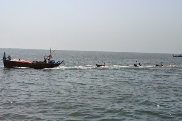 A scenic view of Do Darya Karachi at sunset with a person fishing near the shore.