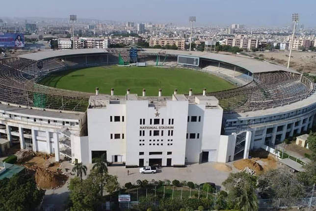 The entrance gates of National Stadium Karachi with fans arriving.