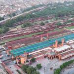 An aerial view of Lahore Railway Station with multiple nearby hotels visible in the surrounding area.