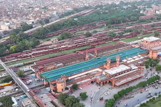 An aerial view of Lahore Railway Station with multiple nearby hotels visible in the surrounding area.