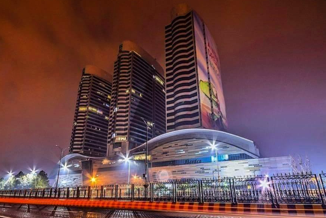 A stunning aerial view of The Centaurus Residences at night, illuminated against the Islamabad skyline.